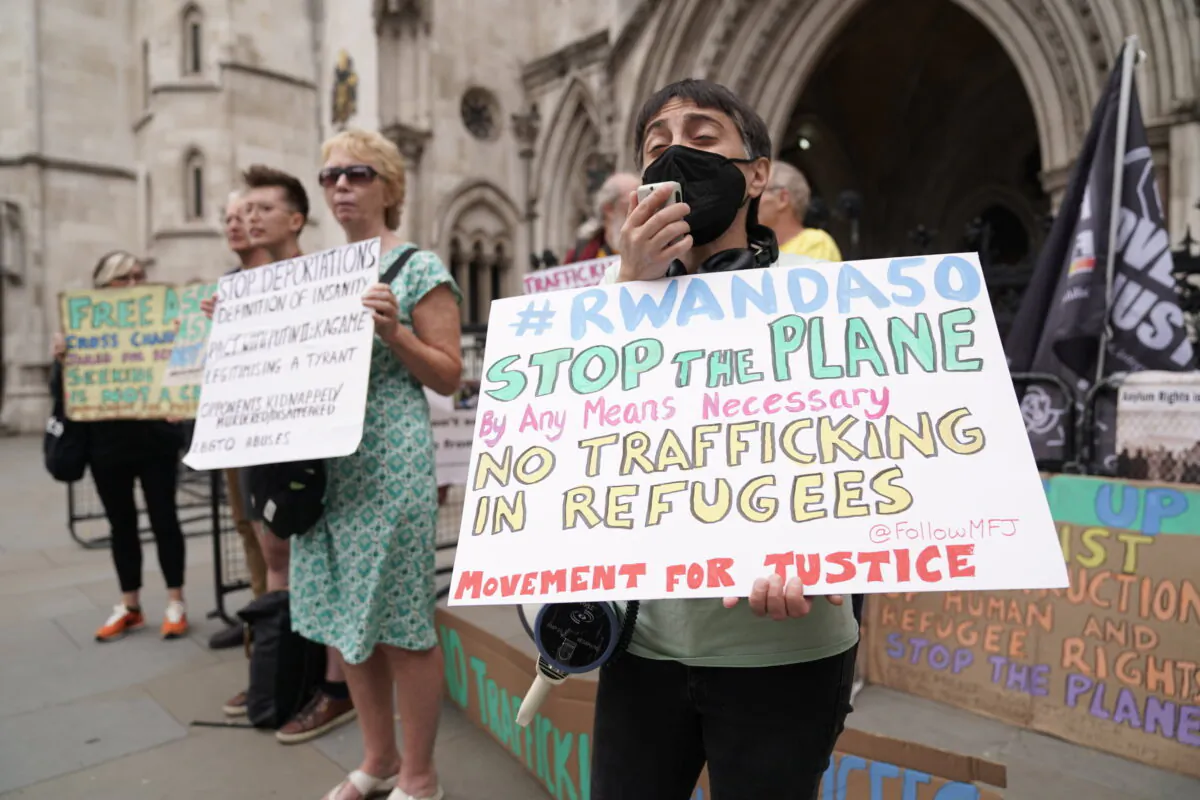Protesters outside the High Court in London for the ruling on Rwanda deportation flights, on June 13, 2022. (Aaron Chown/PA)