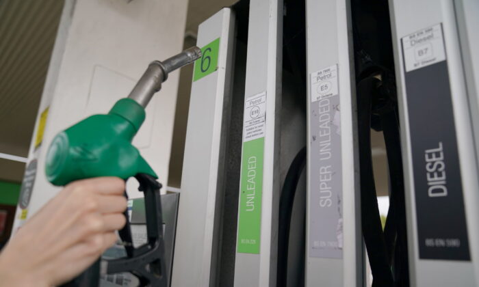 Undated photo showing a person taking a pump at a petrol station. (Joe Giddens/PA Media)