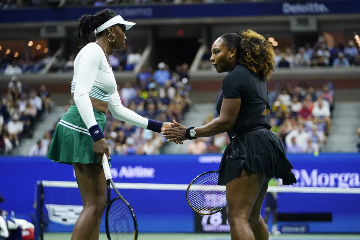 Serena Williams (R) and Venus Williams of the United States celebrate during their first-round doubles match against Lucie Hradecká and Linda Nosková of the Czech Republic at the U.S. Open tennis championships in New York on Sept. 1, 2022. (Frank Franklin II/AP Photo)