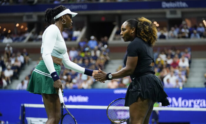 Serena Williams (R) and Venus Williams of the United States celebrate during their first-round doubles match against Lucie Hradecká and Linda Nosková of the Czech Republic at the U.S. Open tennis championships in New York on Sept. 1, 2022. (Frank Franklin II/AP Photo)