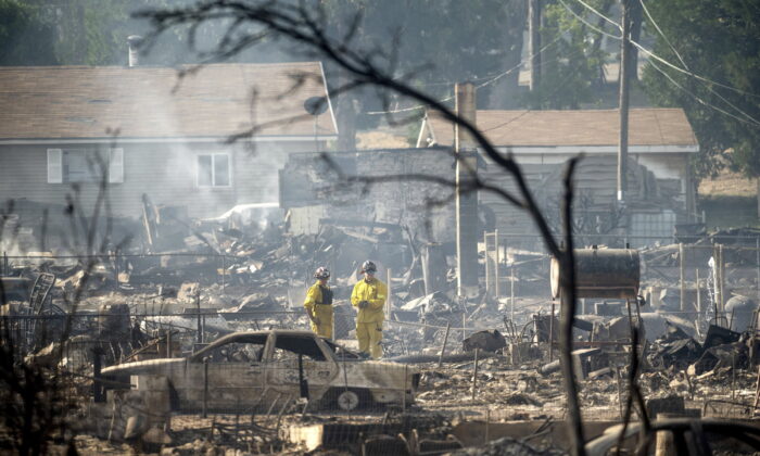 Firefighters survey homes on Wakefield Avenue destroyed by the Mill Fire in Weed, Calif., on Sept. 3, 2022. (Noah Berger/AP Photo)