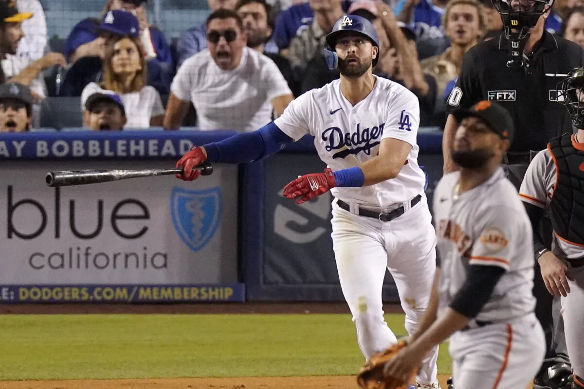 Los Angeles Dodgers' Joey Gallo, left, hits a three-run home run as San Francisco Giants relief pitcher Jarlin Garcia, right, watches during the second inning of a baseball game in Los Angeles, Sept. 6, 2022. (Mark J. Terrill/AP Photo)
