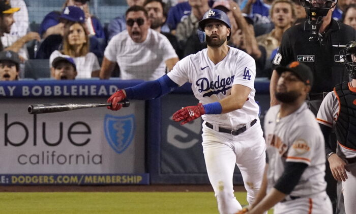 Los Angeles Dodgers' Joey Gallo, left, hits a three-run home run as San Francisco Giants relief pitcher Jarlin Garcia, right, watches during the second inning of a baseball game in Los Angeles, Sept. 6, 2022. (Mark J. Terrill/AP Photo)
