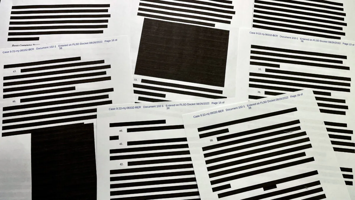 Pages of entirely redacted information are seen in the released version of an affidavit from the Justice Department to support the raid on former President Donald Trump's Mar-a-Lago home in Palm Beach, Fla., in 2022. (Jim Bourg/Reuters)