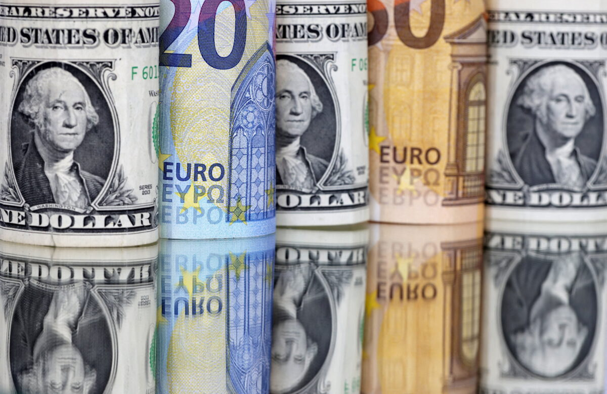 Dollar up on earnings, economy concerns; Euro falls.
