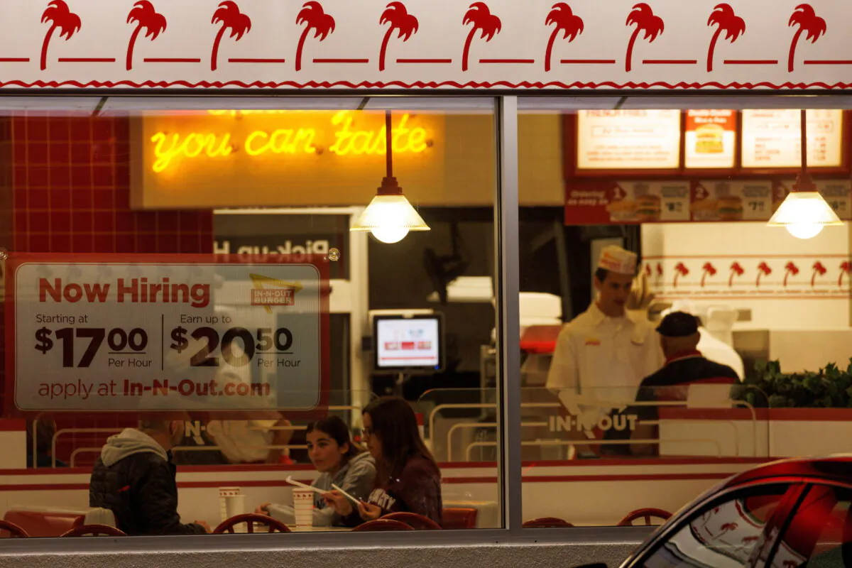 FILE PHOTO: A "Now hiring" sign is displayed on the window of an IN-N-OUT fast food restaurant in Encinitas, California, U.S., May 9, 2022. (Mike Blake/Reuters)