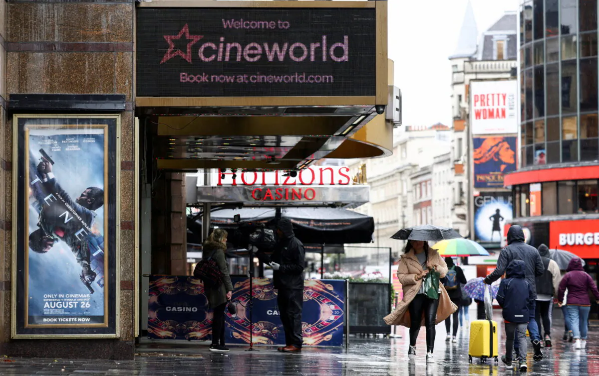 People walk past a Cineworld in Leicester Square during the COVID-19 outbreak in London, on Oct. 4, 2020. (Henry Nicholls/Reuters)