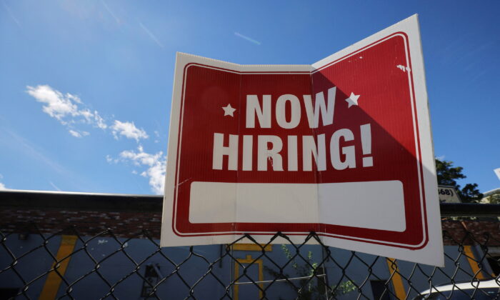A "now hiring" sign outside Taylor Party and Equipment Rentals in Somerville, Mass., on Sept. 1, 2022. (Brian Snyder/Reuters)