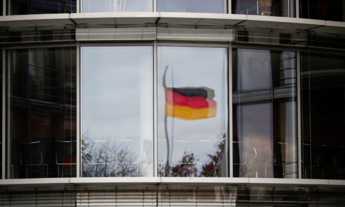 A German flag is reflected in the window of the Paul Loebe building in Berlin, Germany, on Nov. 19, 2020. (Hannibal Hanschke/Reuters)