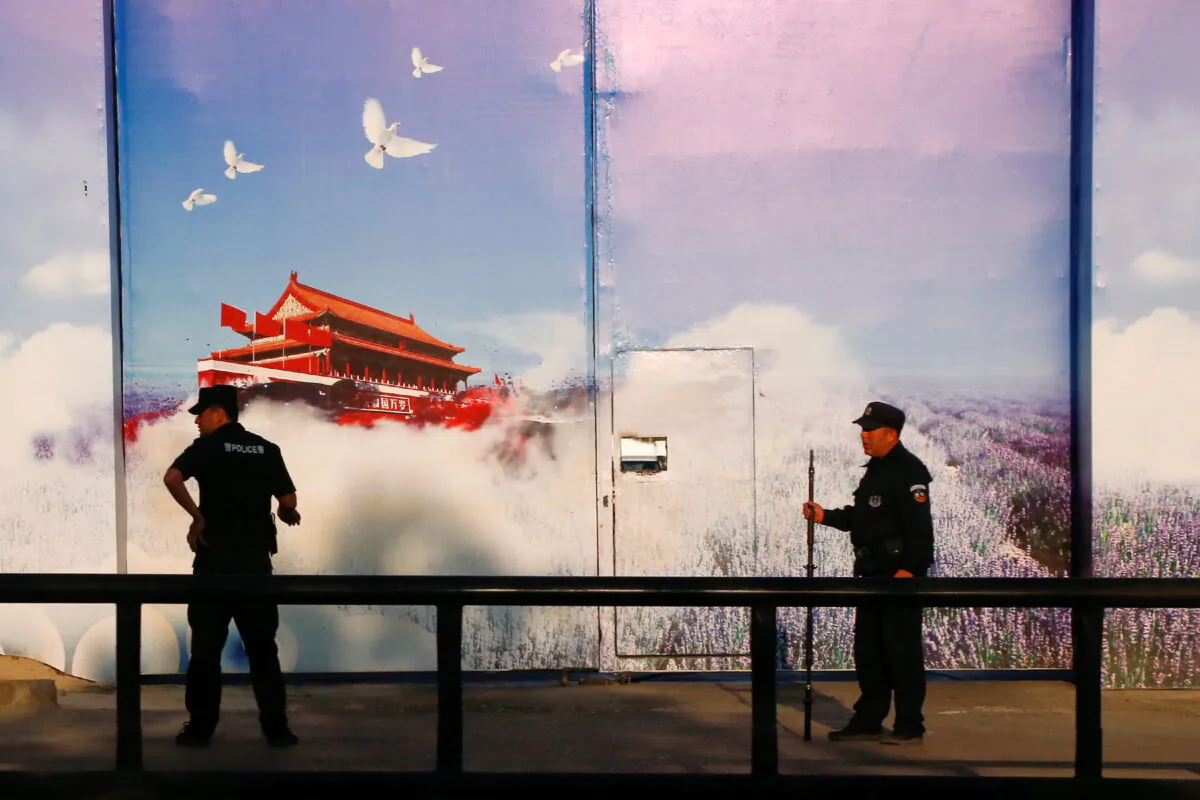 Security guards stand at the gates of what's officially known as a vocational skills education center in Huocheng County in the Xinjiang Uyghur Autonomous Region, China, on Sept. 3, 2018. (Thomas Peter/Reuters)