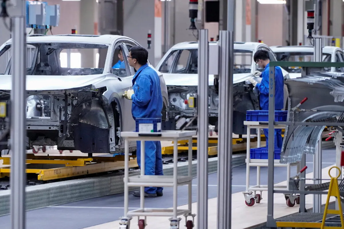 Employees work on assembly line during a construction completion event of SAIC Volkswagen MEB electric vehicle plant in Shanghai, China, on Nov. 8, 2019. (Aly Song/Reuters)
