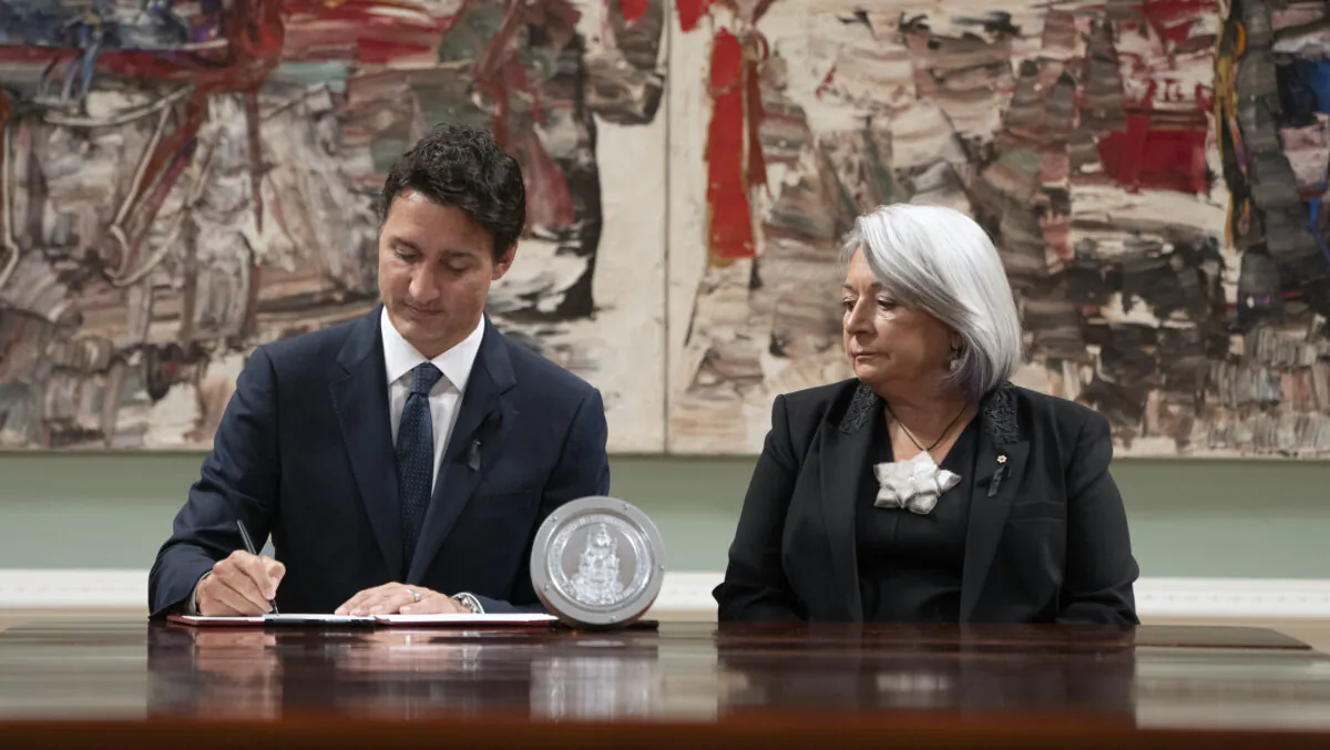 Gov. Gen. Mary Simon looks on as Prime Minister Justin Trudeau signs documents at Rideau Hall in Ottawa on Sept. 10, 2022. (The Canadian Press/Adrian Wyld)