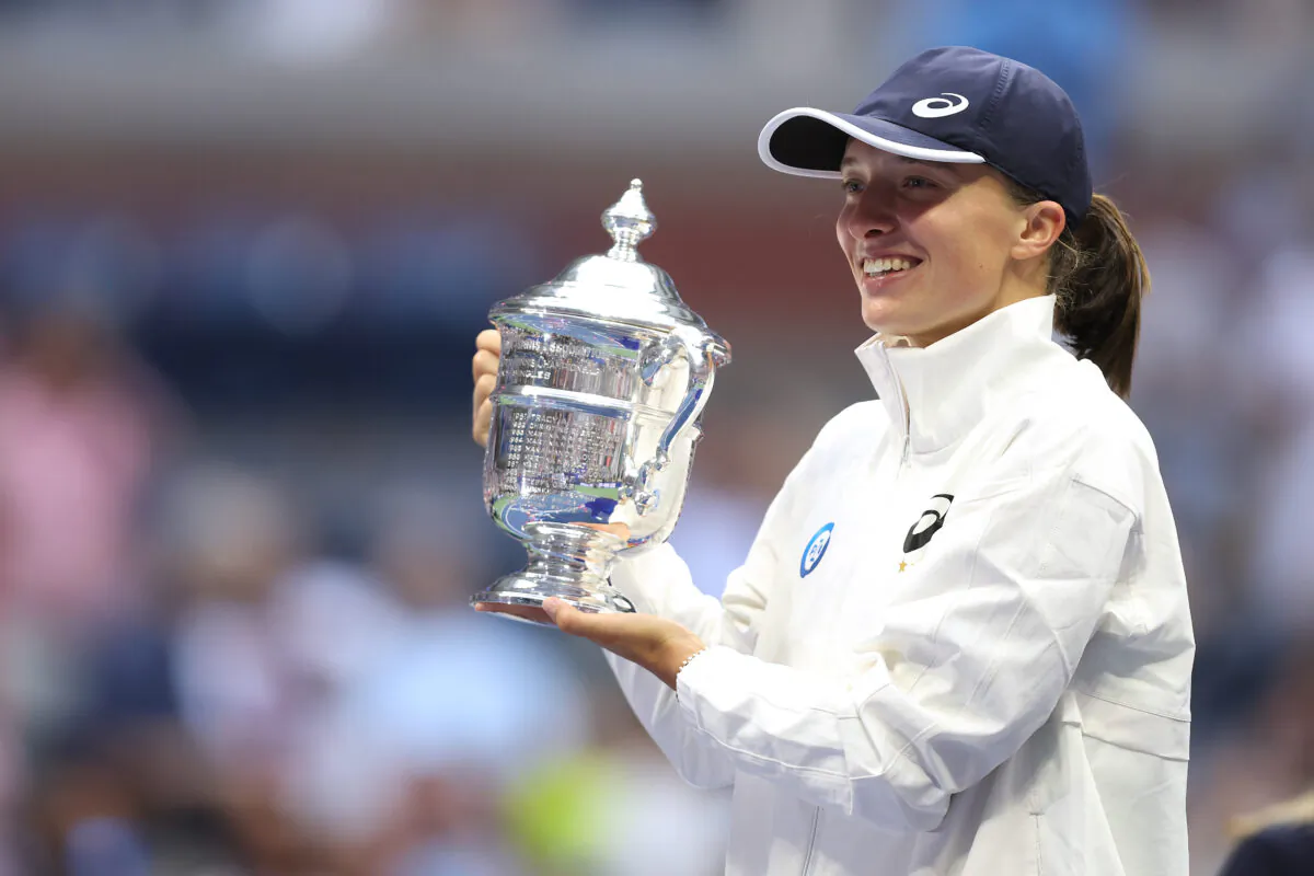 Iga Swiatek of Poland celebrates with the championship trophy after defeating Ons Jabeur of Tunisia during their women’s singles final match at the U.S. Open tennis championships in New York on Sept. 10, 2022. (Julian Finney/Getty Images)