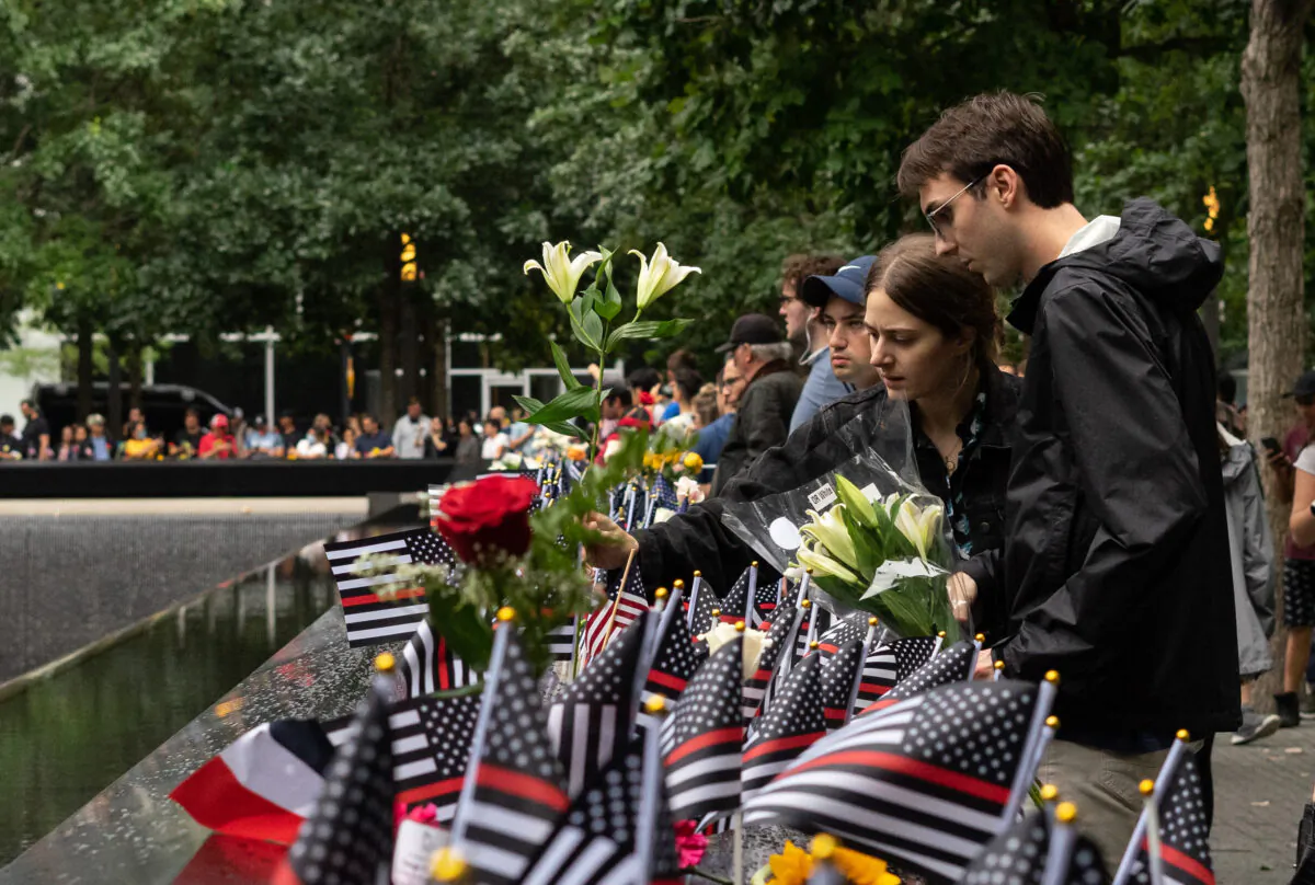People pay respects at the National September 11 Memorial Museum in New York on Sept. 11, 2022. (Chung I Ho/The Epoch Times)