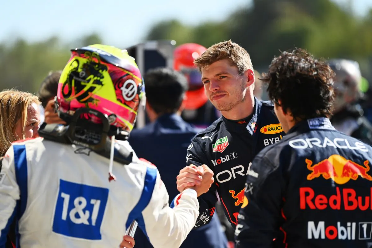 Race winner Max Verstappen of the Netherlands and Oracle Red Bull Racing is congratulated by sixteenth placed Kevin Magnussen of Denmark and Haas F1 in parc ferme during the F1 Grand Prix of Italy at the Autodromo Nazionale Monza in Monza, Italy, on Sept. 11, 2022. (Dan Mullan/Getty Images)