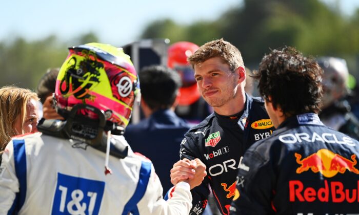 Race winner Max Verstappen of the Netherlands and Oracle Red Bull Racing is congratulated by sixteenth placed Kevin Magnussen of Denmark and Haas F1 in parc ferme during the F1 Grand Prix of Italy at the Autodromo Nazionale Monza in Monza, Italy, on Sept. 11, 2022. (Dan Mullan/Getty Images)