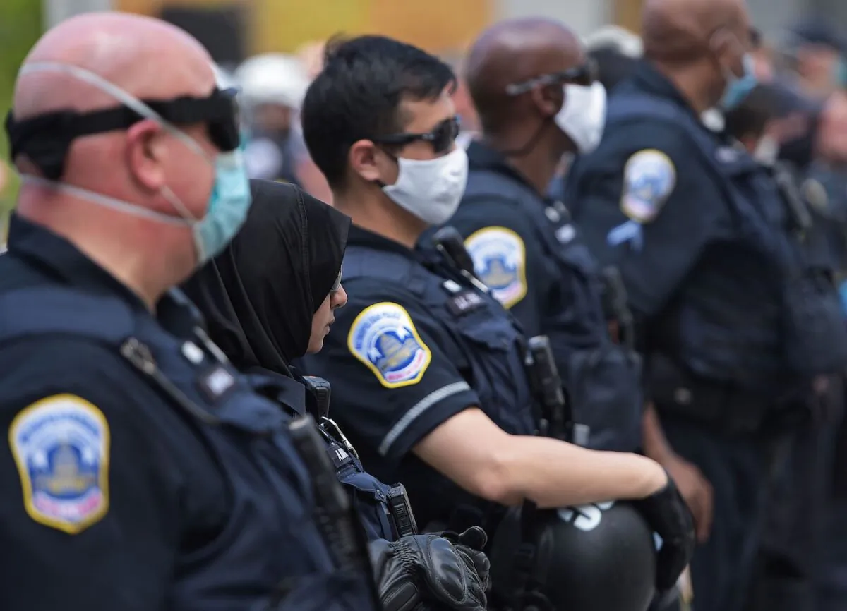 Police officers stand near the White House in Washington, on June 23, 2020. (Brendan Smialowski/AFP via Getty Images)
