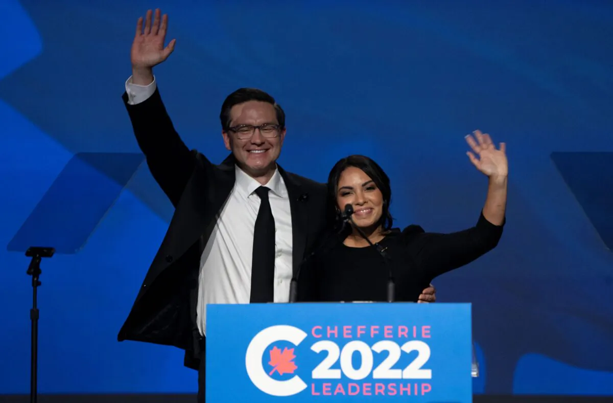 Newly elected Conservative Leader Pierre Poilievre and his wife Anaida wave as they take the stage at the Shaw Centre in Ottawa on Sept. 10, 2022. (The Canadian Press/Adrian Wyld)