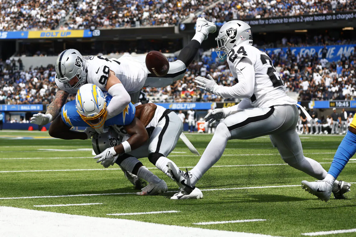 Tight end Tre' McKitty (88) of the Los Angeles Chargers fails to catch a pass while being hit by cornerback Nate Hobbs (39) of the Las Vegas Raiders defensive end Maxx Crosby (98) of the Las Vegas Raiders, and safety Johnathan Abram (24) of the Las Vegas Raiders at SoFi Stadium in Inglewood, Calif., on Sept. 11, 2022. (Ronald Martinez/Getty Images)
