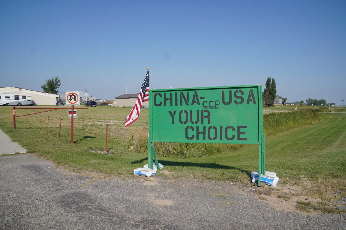 A sign opposing a corn mill in Grand Forks, N.D., stands near 370 acres recently annexed by the city for the project. Many residents don't want the project in the city because the owner, Fufeng Group, has reputed ties to the Chinese Communist Party through its company chairman. (Allan Stein/The Epoch Times)