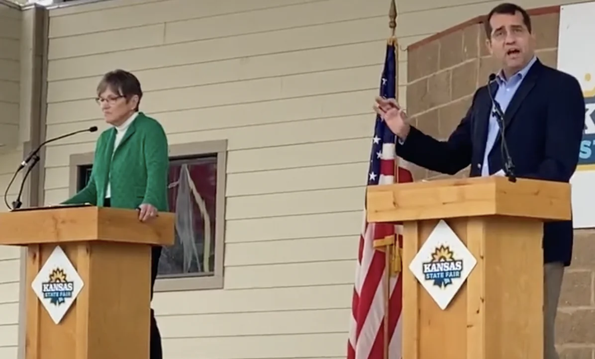 Kansas Attorney General and Republican gubernatorial candidate Derek Schmidt tells the audience that incumbent Democrat Laura Kelly (left) has "done more damage than any governor in the history of the state" during their Sept. 10 debate at the Kansas State Fair in Hutchison. (Courtesy of Schmidt for Kansas)