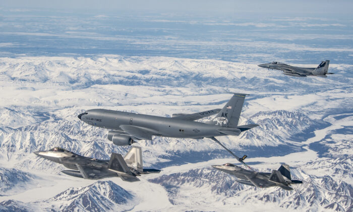 A KC-135 Stratotanker from the 168th Air Refueling Wing refuels F-22 Raptors from the 3rd Wing over the Joint Pacific Alaska Range Complex flying along side with an F-15 Eagles from the 144th Fighter Wing, on April 18, 2022. (Air National Guard photo by Master Sgt. Charles Vaughn)