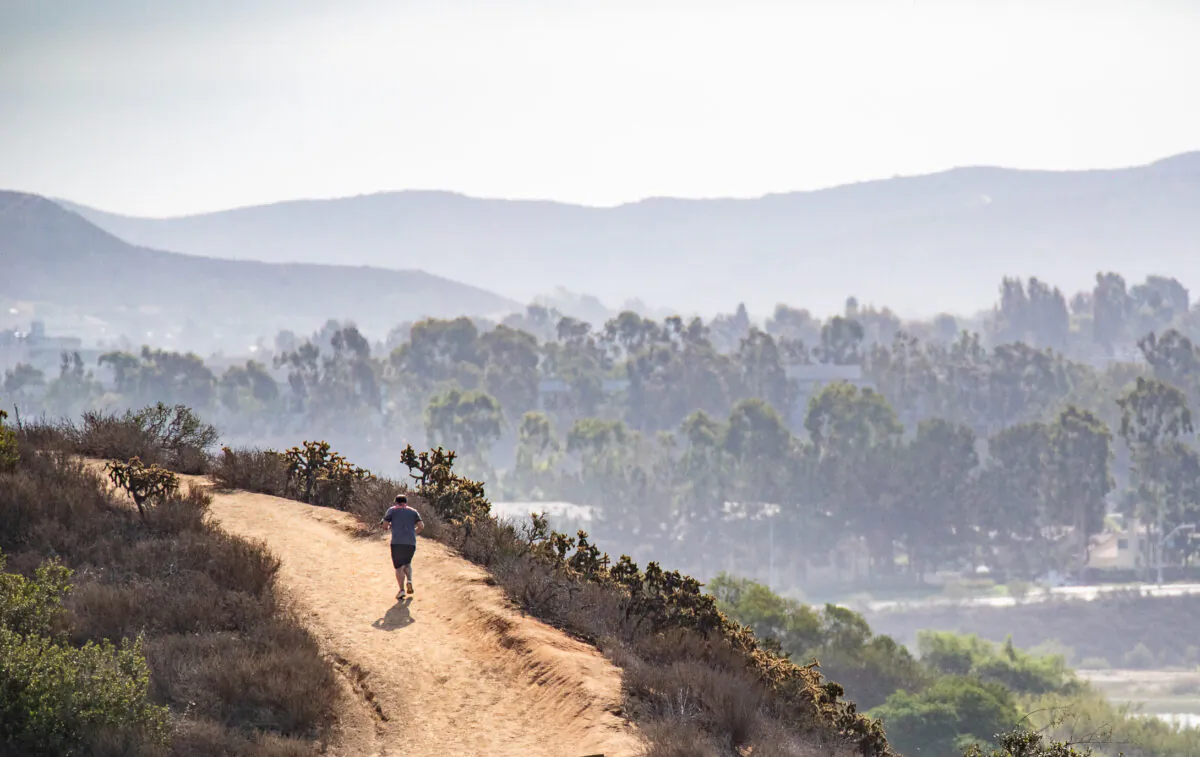 A man jogs around the back bay in Newport Beach, Calif., on Sept. 8, 2022. (John Fredricks/The Epoch Times)