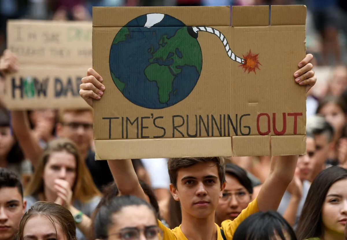 A demonstrator holds a placard reading "time is running out" during a protest in Barcelona on Sept. 27, 2019. (Josep Lago/AFP via Getty Images)