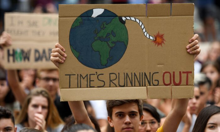 A demonstrator holds a placard reading "time is running out" during a protest in Barcelona on Sept. 27, 2019. (Josep Lago/AFP via Getty Images)