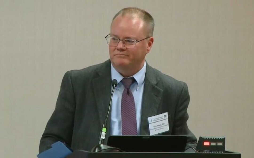 In this file image from video, David Christian Hassell, a Department of Health and Human Services official who chairs the Potential Pandemic Pathogen Care and Oversight (P3CO) Review Committee, speaks during a government meeting. (Screenshot via The Epoch Times)