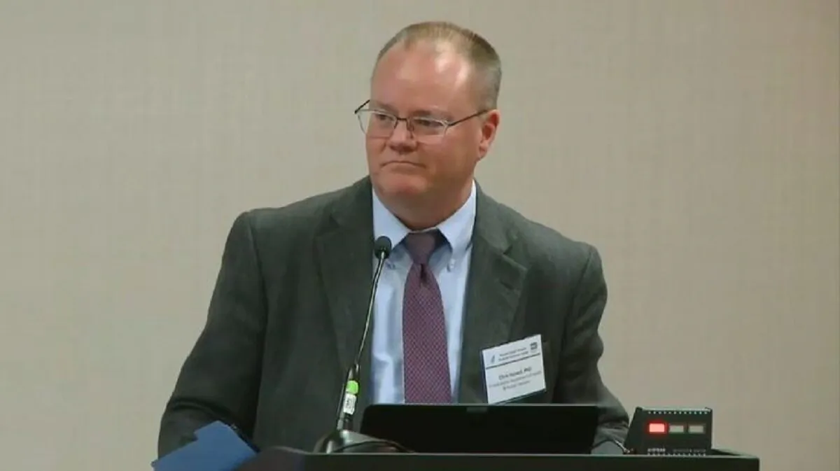 In this file image from video, David Christian Hassell, a Department of Health and Human Services official who chairs the Potential Pandemic Pathogen Care and Oversight (P3CO) Review Committee, speaks during a government meeting. (Screenshot via The Epoch Times)