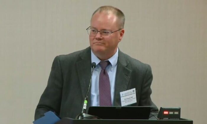 In this file image from video, Christopher Hassell, a Department of Health and Human Services official who chairs the Potential Pandemic Pathogen Care and Oversight (P3CO) Review Committee, speaks during a government meeting. (Screenshot via The Epoch Times)