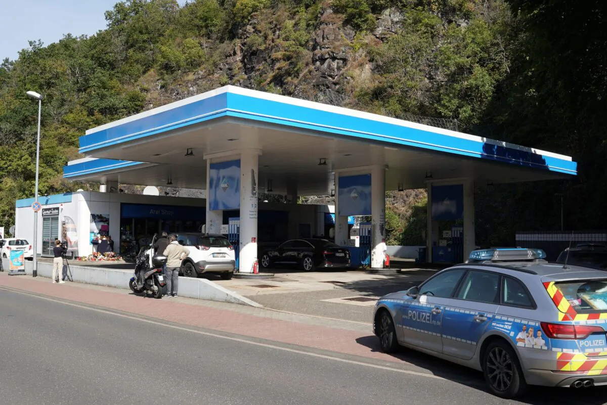 Media and a police car stand in front of a gas station in Idar-Oberstein, Germany, on Sept. 21, 2021. (Thomas Frey/dpa via AP)