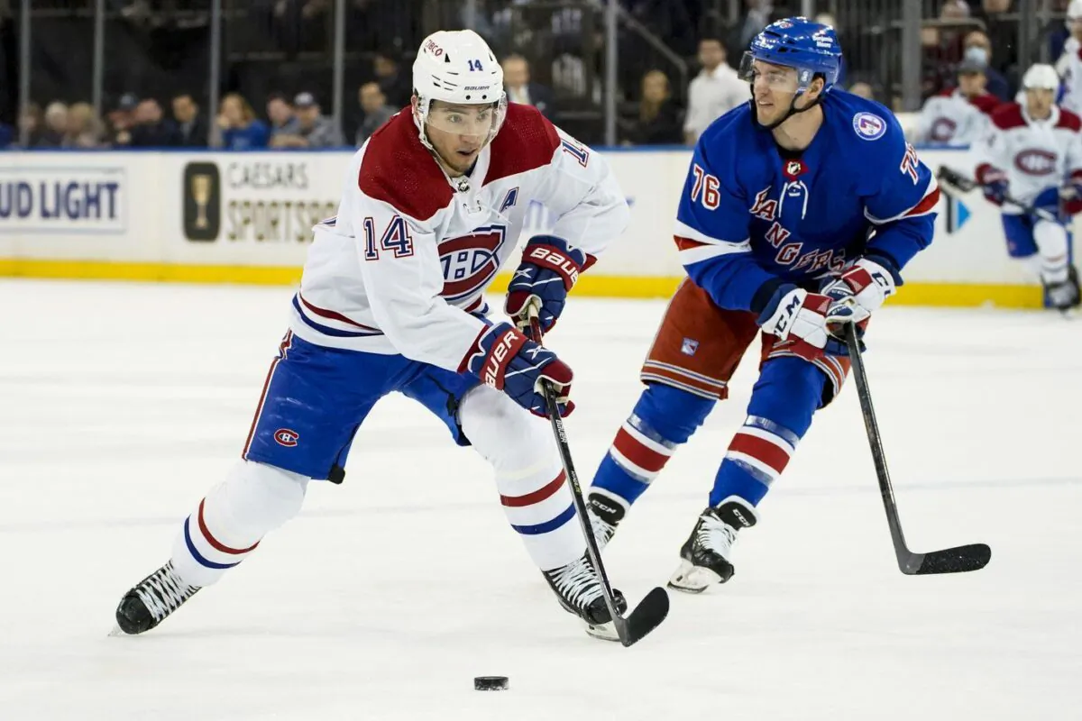 Montreal Canadiens center Nick Suzuki (14) skates the puck past New York Rangers center Jonny Brodzinski (76) during the first period of an NHL hockey game, April 27, 2022, in New York. (The Canadian Press/AP-John Minchillo