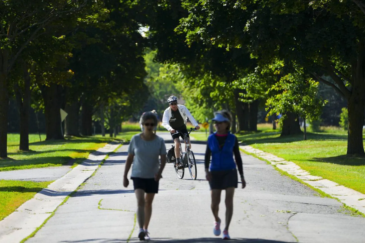People make their way along Morningside Lane in Ottawa on July 13, 2022.(The Canadian Press/Sean Kilpatrick)