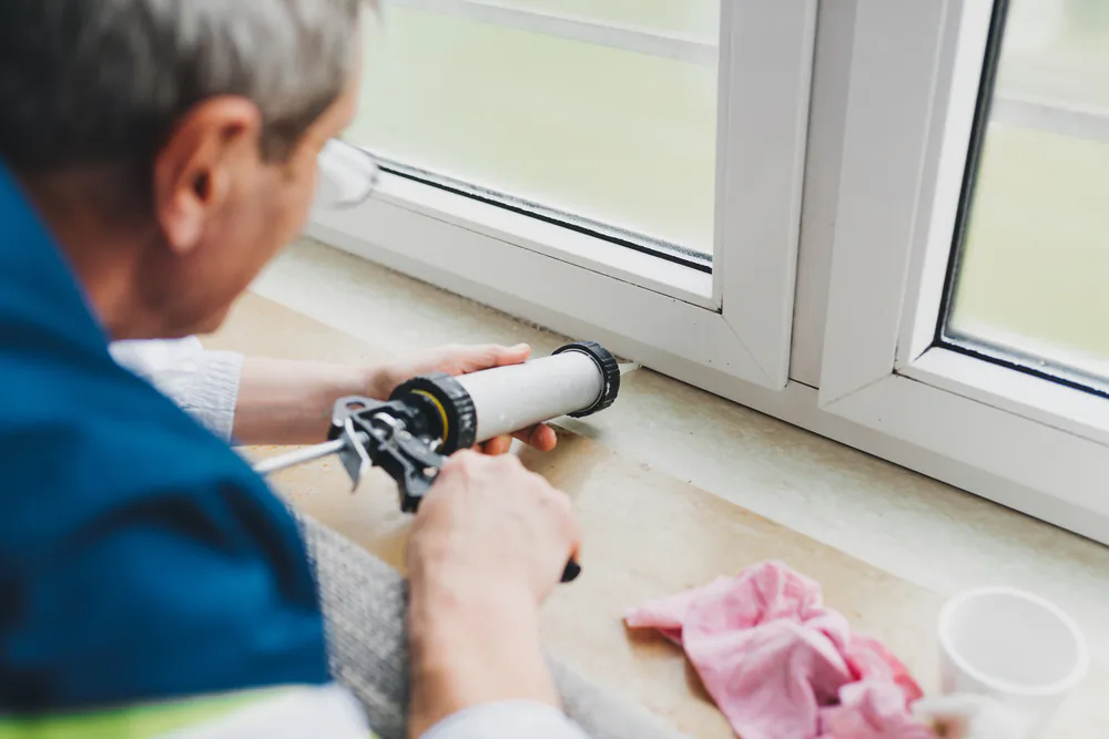 Check all the windows and doors for damaged or missing caulk and make any necessary repairs. (veryulissa/Shutterstock)