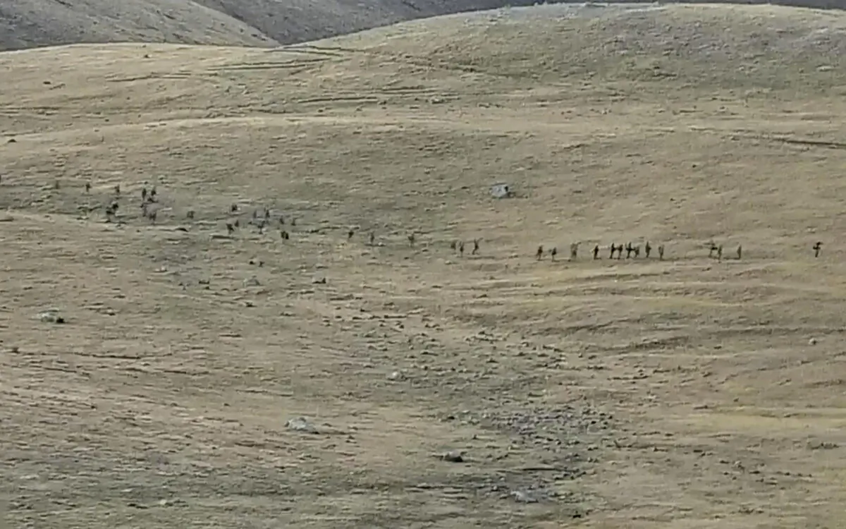 Azerbaijanian servicemen cross the Armenian–Azerbaijani border and approach the Armenian positions in a still from video released on Sept. 13, 2022. (Armenian Defense Ministry via AP)