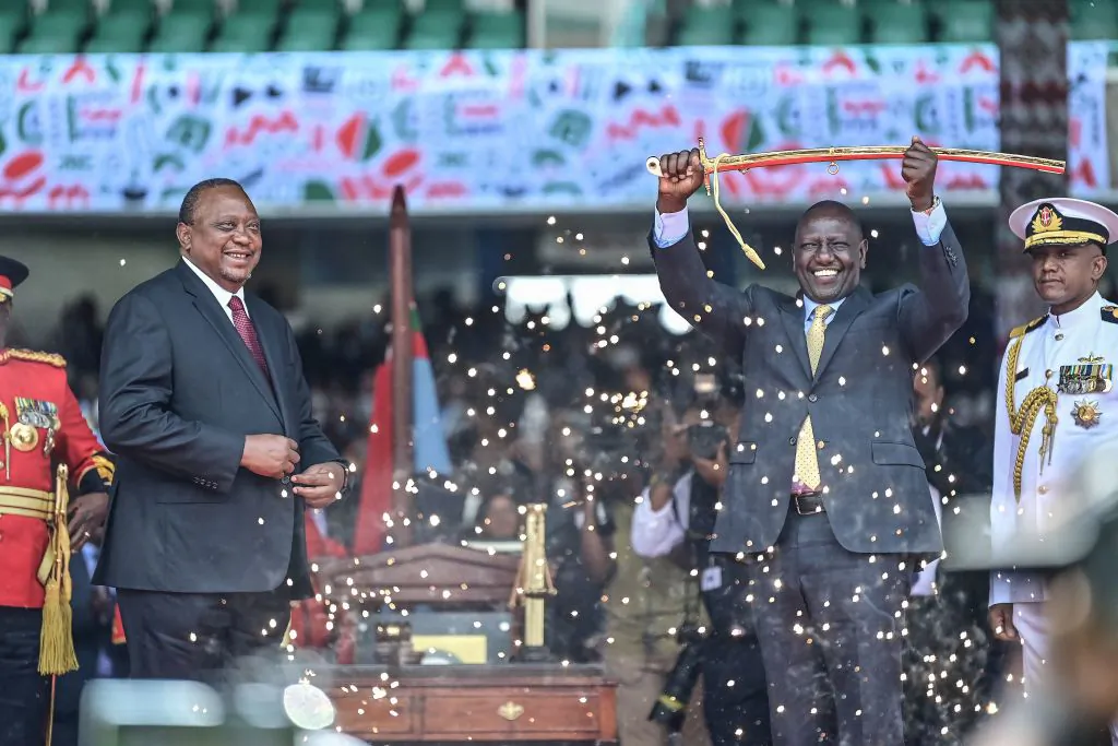 Outgoing Kenya President Uhuru Kenyatta looks on as President William Ruto lifts a sword during the inauguration ceremony at the Moi International Sports Center Kasarani in Nairobi, Kenya, on Sept. 13, 2022. (Tony Karumba/AFP via Getty Images)