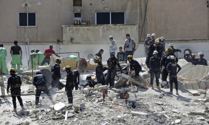 Jordanian Civil Defense rescue teams conduct a search operation for residents of a four-story residential building that collapsed in the Jordanian capital of Amman on Sept. 14, 2022. (Raad Adayleh/AP Photo)