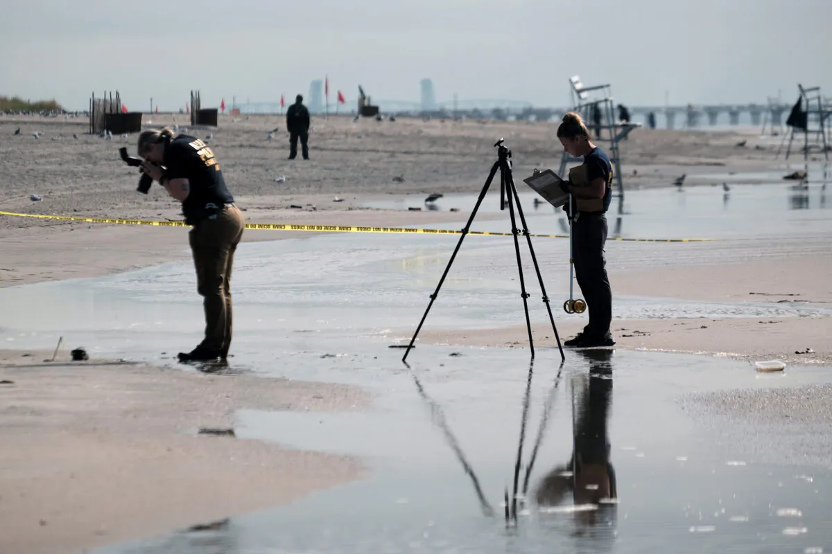 Police work along a stretch of beach at Coney Island which is now a crime scene after a mother is suspected of drowning her children in the ocean in the Brooklyn borough of N.Y., on Sept. 12, 2022. (Spencer Platt/Getty Images)