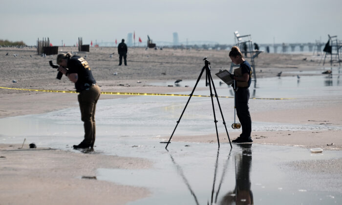 Police work along a stretch of beach at Coney Island which is now a crime scene after a mother is suspected of drowning her children in the ocean in the Brooklyn borough of N.Y., on Sept. 12, 2022. (Spencer Platt/Getty Images)
