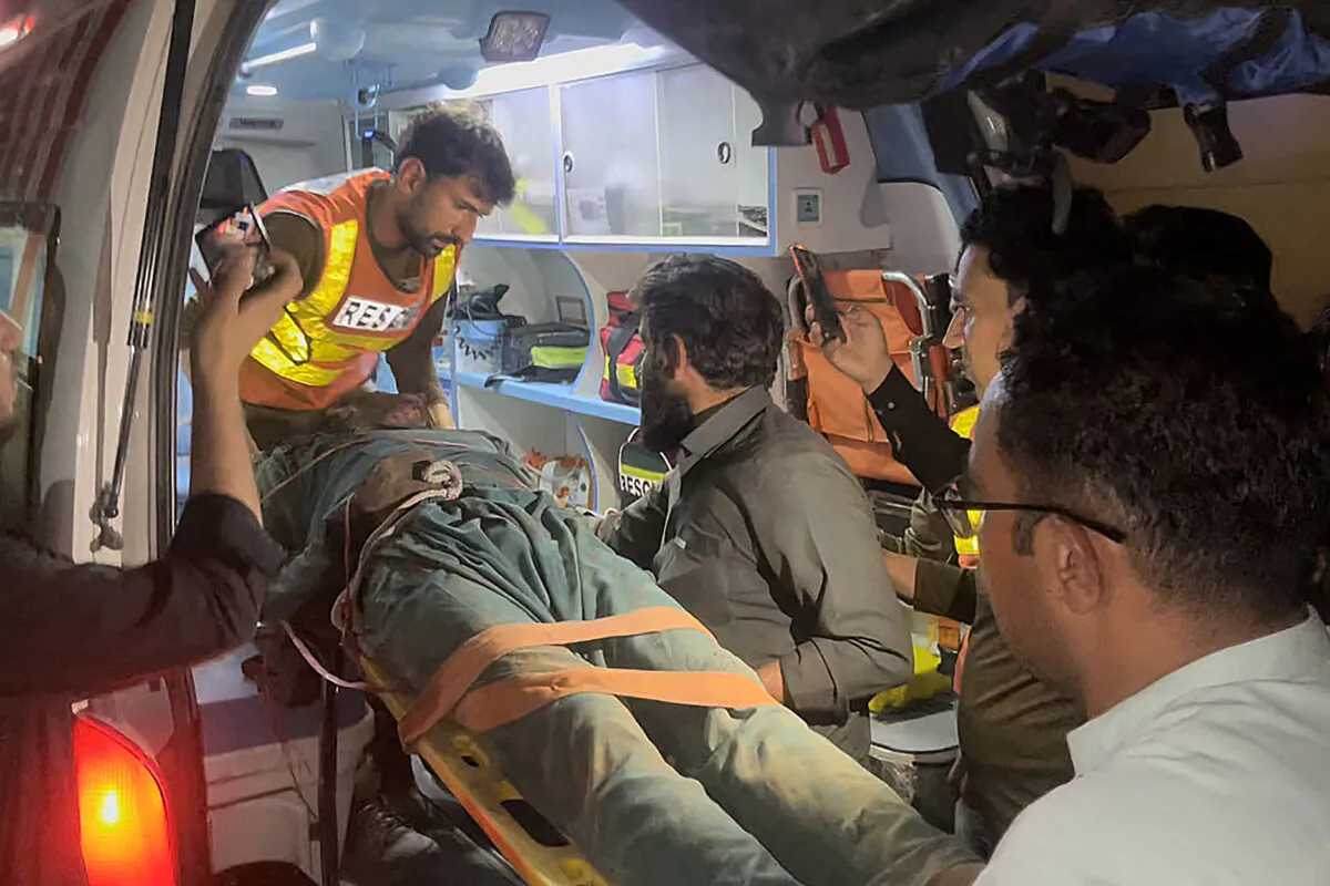 Rescue workers carry the body of a blast victim into an ambulance following an overnight bomb blast in Pakistan's northwest Swat valley on Sept. 13, 2022. (AFP via Getty Images)