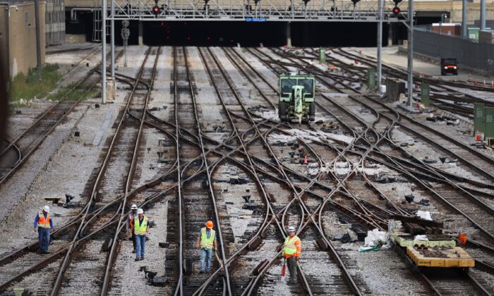 Workers service the tracks at the Metra/BNSF railroad yard outside of downtown Chicago, on Sept. 13, 2022. (Scott Olson/Getty Images)