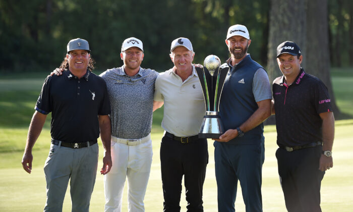 (L–R) Pat Perez, LIV Golf commissioner Greg Norman, Talor Gooch, Dustin Johnson, and Patrick Reed pose with the trophy after winning the team title at the LIV Golf Invitational - Portland at Pumpkin Ridge Golf Club in North Plains, Ore., on July 2, 2022. (Steve Dykes/Getty Images)