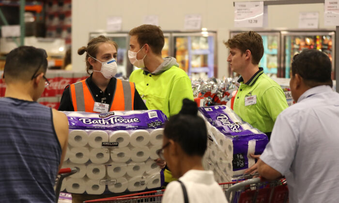 Staff members assist shoppers at Costco Perth in Perth, Australia, on March 19, 2020. (Paul Kane/Getty Images)