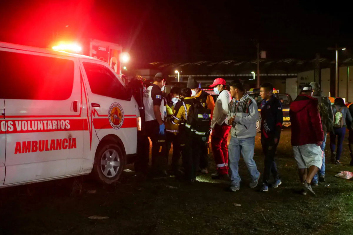 Paramedics and government officials stand at a scene following a stampede at a concert to commemorate the country's Independence Day that left people dead and injured, in Quetzaltenango, Guatemala, on Sept. 15, 2022. (Stringer/Reuters)