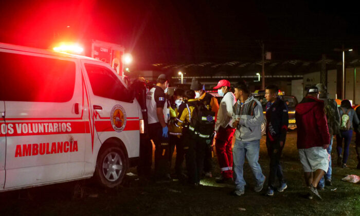 Paramedics and government officials stand at a scene following a stampede at a concert to commemorate the country's Independence Day that left people dead and injured, in Quetzaltenango, Guatemala, on Sept. 15, 2022. (Stringer/Reuters)