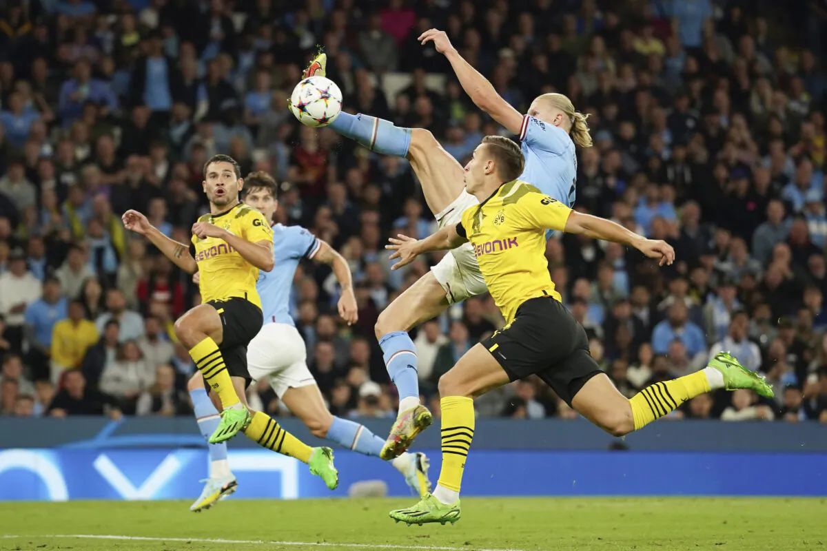 Manchester City's Erling Haaland, right, scores his side's 2nd goal during the group G Champions League soccer match between Manchester City and Borussia Dortmund at the Etihad stadium in Manchester, England, on Sept. 14, 2022. (Dave Thompson/AP Photo)