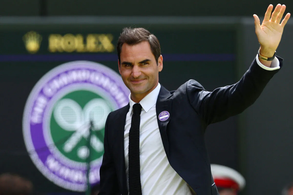 Swiss tennis player Roger Federer waves during the Centre Court Centenary Ceremony on the seventh day of the 2022 Wimbledon Championships at The All England Tennis Club in Wimbledon, southwest London, on July 3, 2022. (Adrian Dennis/AFP via Getty Images)