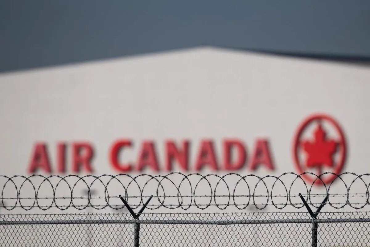 An Air Canada hangar is seen behind a security fence at Vancouver International Airport, in Richmond, B.C., on March 20, 2020. (The Canadian Press/Darryl Dyck)